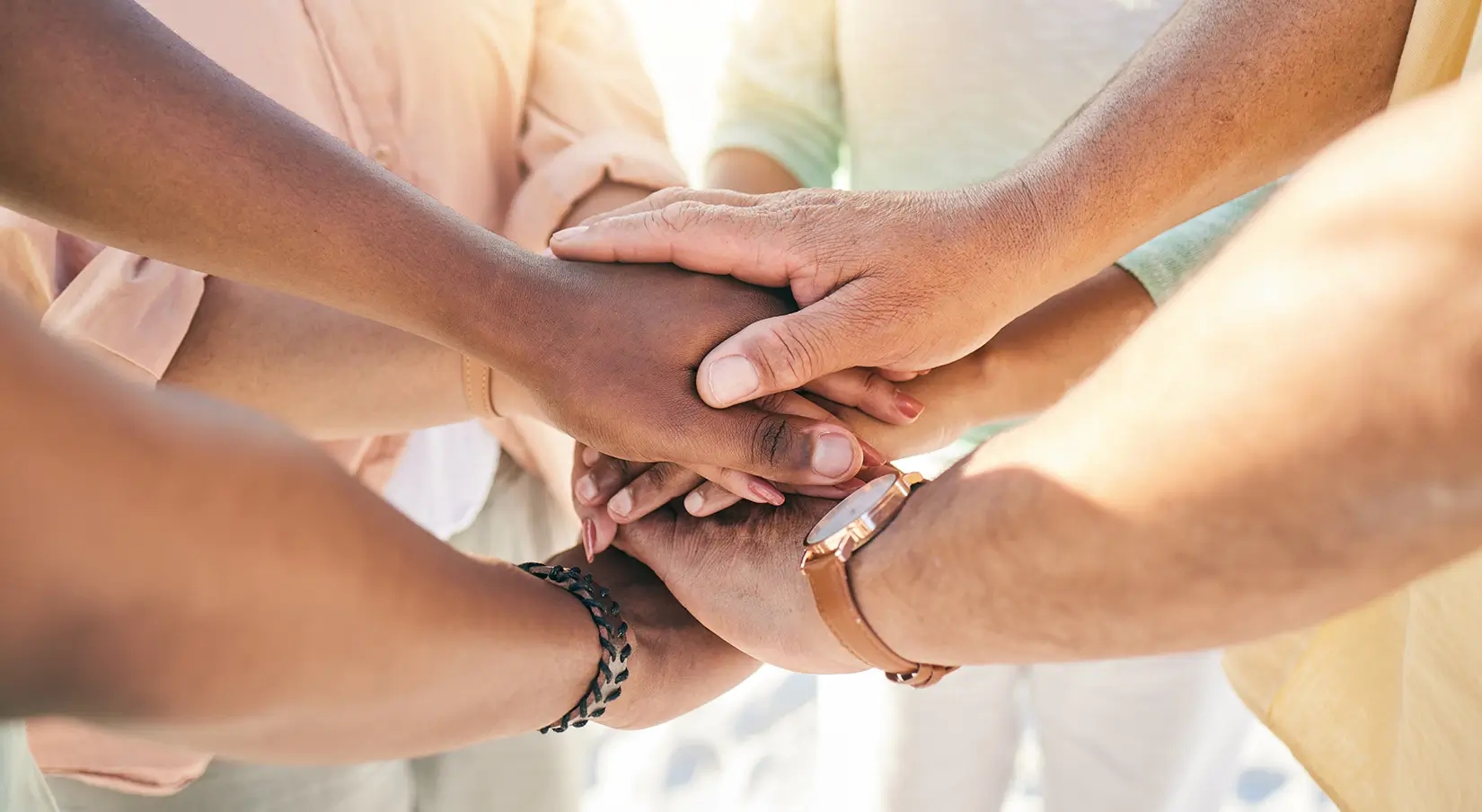 group-of-people-hands-stacked-outdoor-for-teamwork-2023-11-27-04-53-12-utc